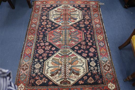 A North West Persian indigo ground rug, with figured triple octagonal pole medallion, 180cm x 135cm
